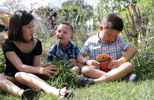 Children look at plants in a garden