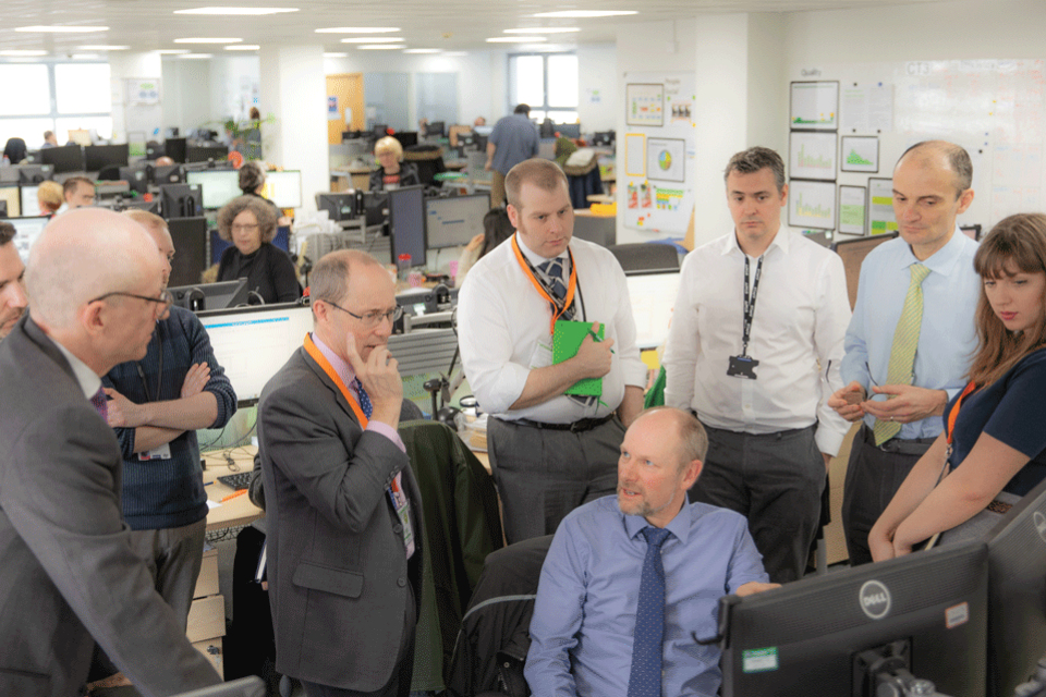 Croydon Office registration expert Ian Thomas (seated) briefs Geospatial Commission Chair Sir Andrew Dilnot (fifth from right)