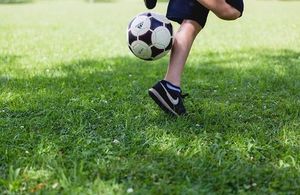 A child kicking a football