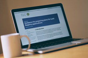 A laptop computer displaying guidance for preparing plans for Land Registry applications