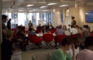 a group of participants are listening to a facilitator