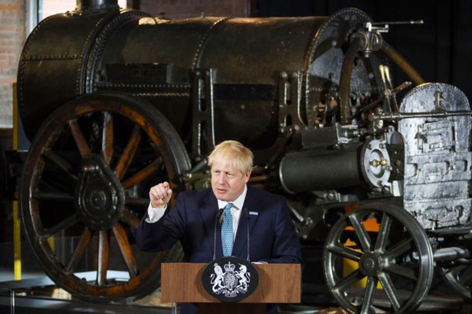 Photo of Boris Johnson in front of Stephenson's rocket.