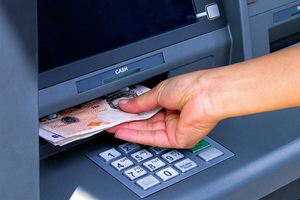 Cash inserted into an ATM machine 