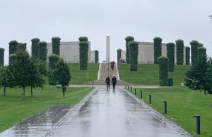 Two personnel climb steps at the National Memorial Arboretum in Staffordshire.