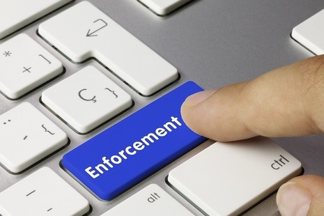 Enforcement word on key board, finger pressing button photo credit Adobe Stock by momius