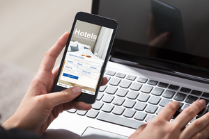 Person on a hotel booking app on a mobile phone