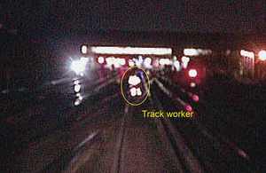 Night time image from forward facing CCTV camera on approaching train showing a trackworker moving across the lines (courtesy of Govia Thameslink Railway)