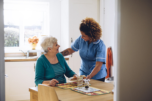 Nurse visiting elderly woman in her home.