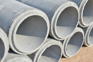 photograph: a number of empty concrete pipes on the ground.