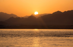 Sun setting behind desert mountains at Sharm El Sheik