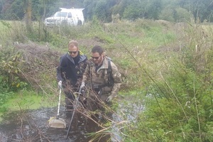 Two fisheries officers wading in the River Stour surveying the river for fish