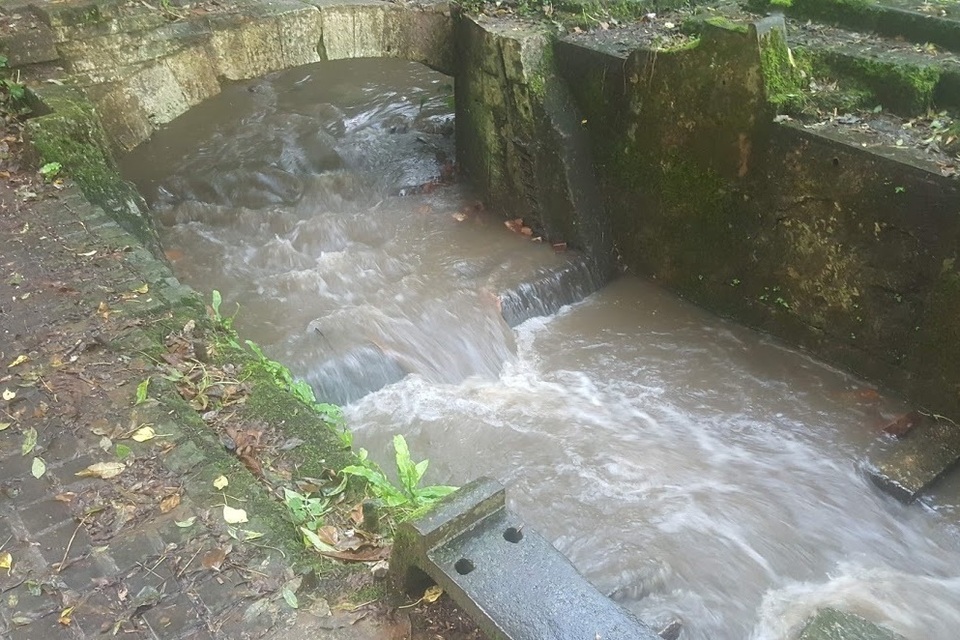 The River Stour, flowing over a small weir that has had a notch cut out of it to help fish migrate upstream