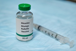 A bottle of MMR vaccine and a syringe