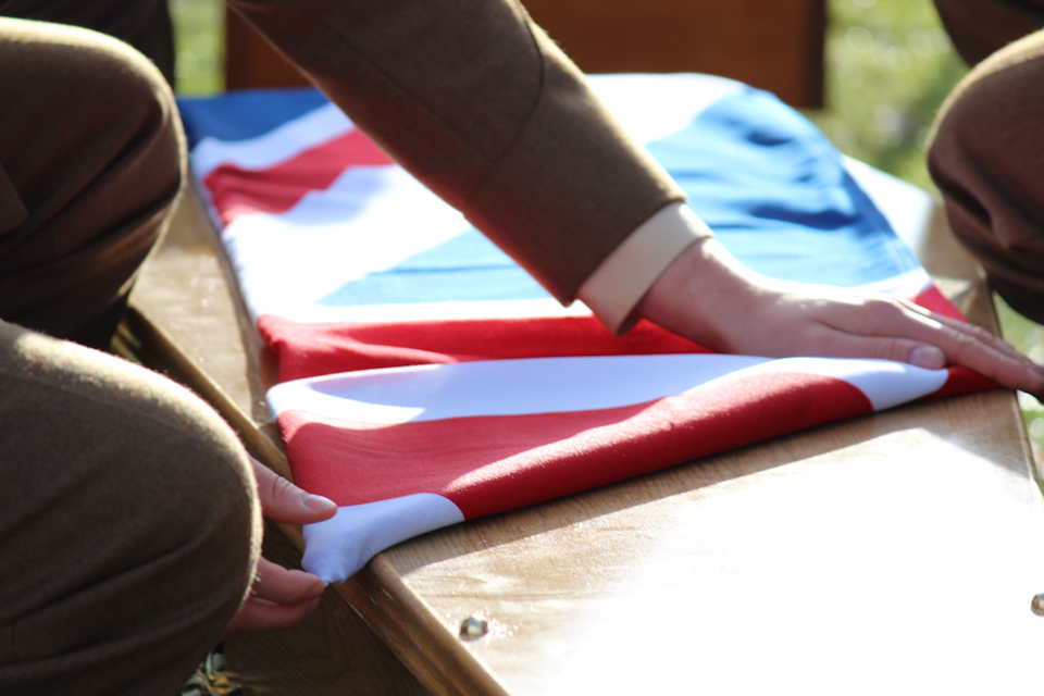 Union Flag is folded as it lays upon the coffin