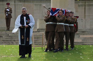Reverend Paul Whitehead leads the soldiers from the 1st Battalion The Royal Anglian Regiment as they carry Lance Corporal Perkins to his final resting place