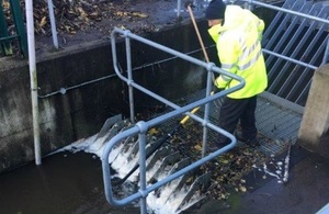 Image of man in high visibility jacket working on a flood gate