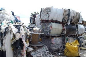 Piles of waste stacked on an illegal waste transfer station outside the permitted area