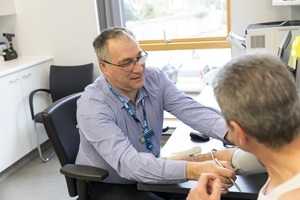 Doctor checking patient's blood pressure