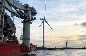 Image of the Port of Blyth wind power generator and ship coming in.