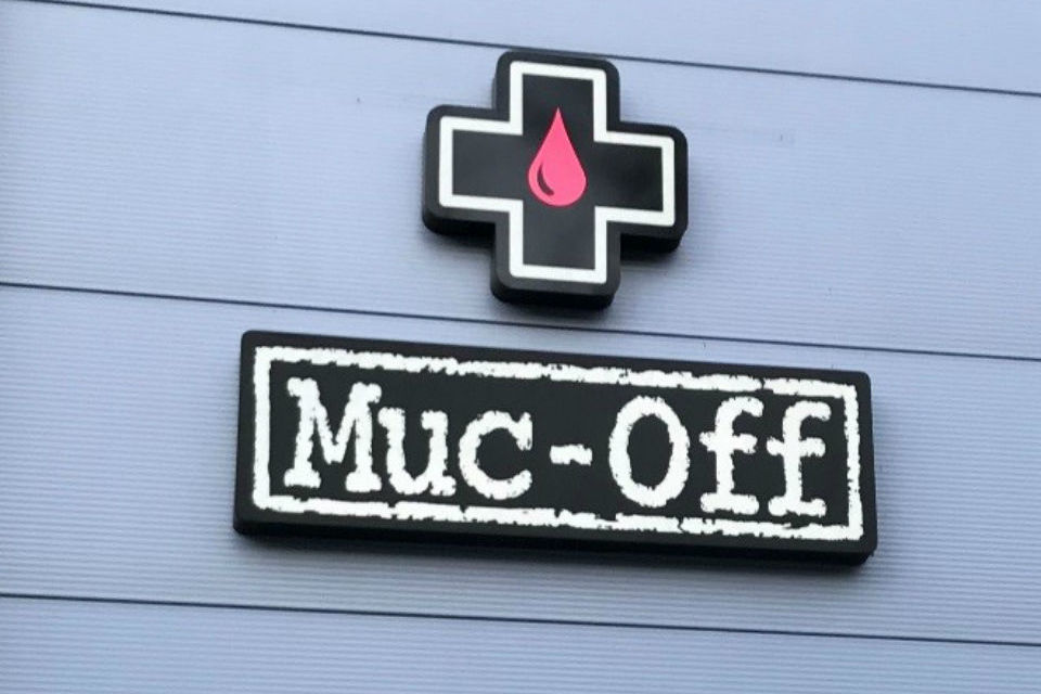 Muc-Off stencil-themed logo outside company's headquarters in Poole