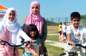 A group of children standing outside with bicycles