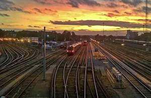 Image of train on tracks at sunset.