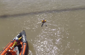 Aerial view of rescue boat approaching a casualty in the water