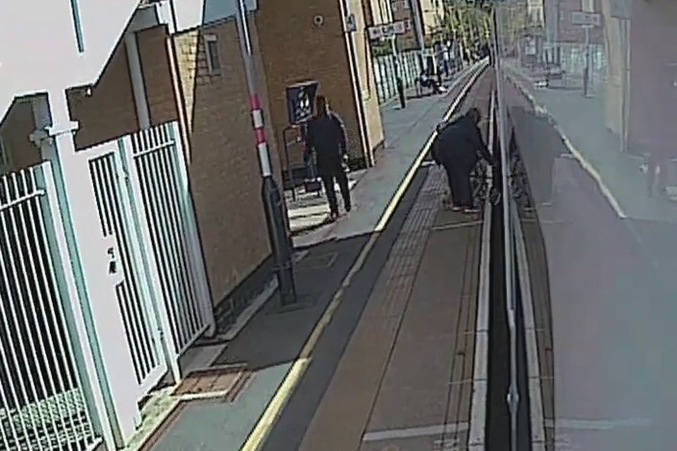 CCTV from the train showing a passenger trying to free their dog trapped in train doors at Elstree & Borehamwood.