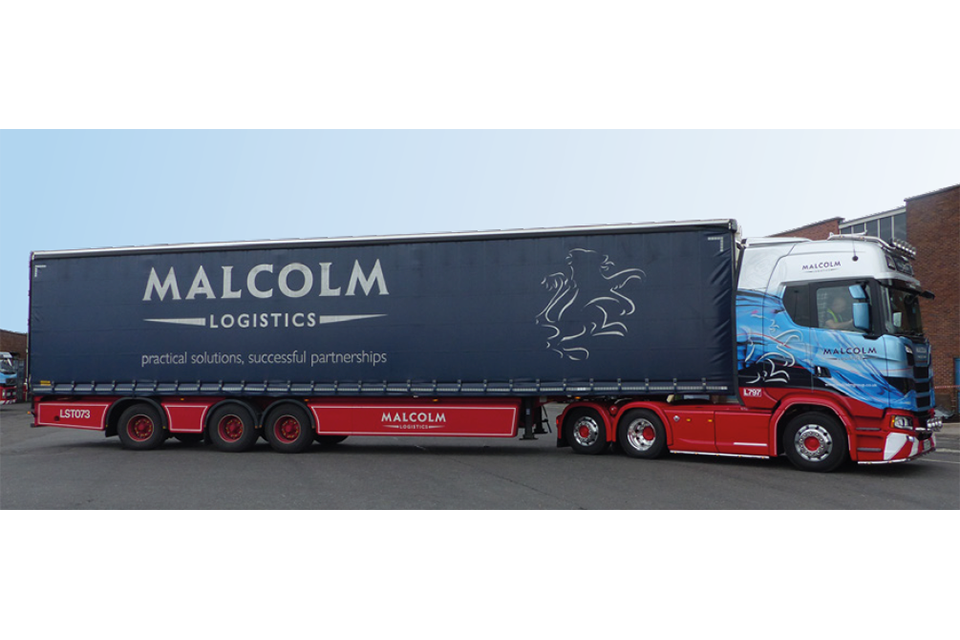 Tractor unit with longer semi-trailer in the livery of Malcolm logistics