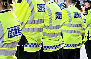 Police officers standing together with their backs to camera