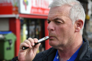 Man inhaling an e-cigarette