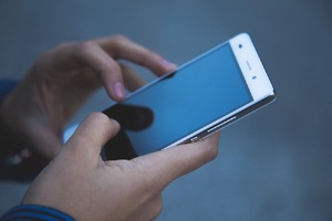 Close-up of the hands of a woman using a smartphone