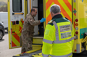A soldier receives health and safety training in use of the hydrolics at the rear of an ambulance.