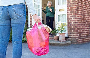 A volunteer delivering shopping