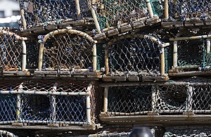 Several lobster pots used for catching lobsters are piled one on top of the other