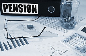 Pension folder and calculator on desk