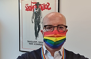 Ambassador Knott wearing a pride-themed mask