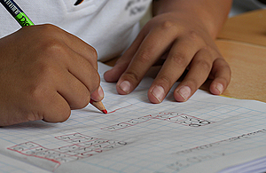 pupil-writing-in-a-work-book