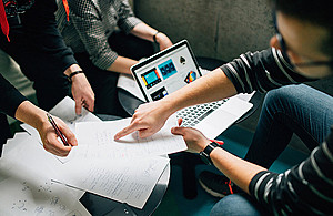 students-working-with-papers-and-laptop