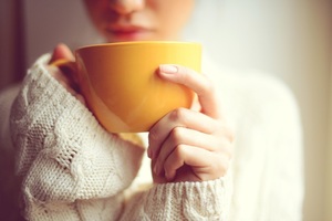 Woman holding coffee cup