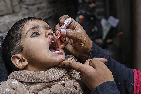 A child is vaccinated against polio in Pakistan