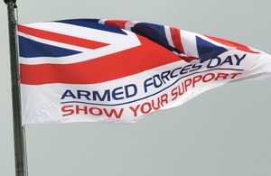 Image showing the UK Armed Forces Day flag flying. The flag says 'Armed Forces Day, show your support'.