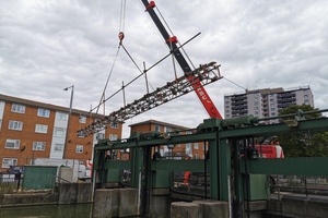 A crane lowers equipment onto the sluice as part of preparations for a structural revamp.
