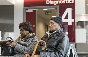 Close-up of elderly couple sitting in diagnostics waiting area