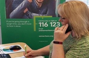 Lady answering a phone call at the Samaritans