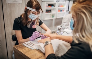 Nail technician wearing PPE