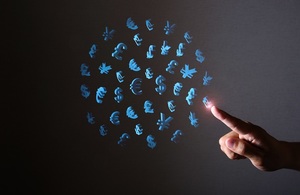 blue currency symbols shaped into a globe with a hand pointing to a pound sign on a black background
