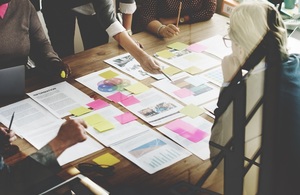 Team sorting out projects using sticky notes