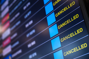 Airport board showing all flights as cancelled.