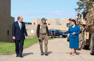 L-R: Ben Wallace, an afghan interpreter and Priti Patel walk through Wretham training Camp